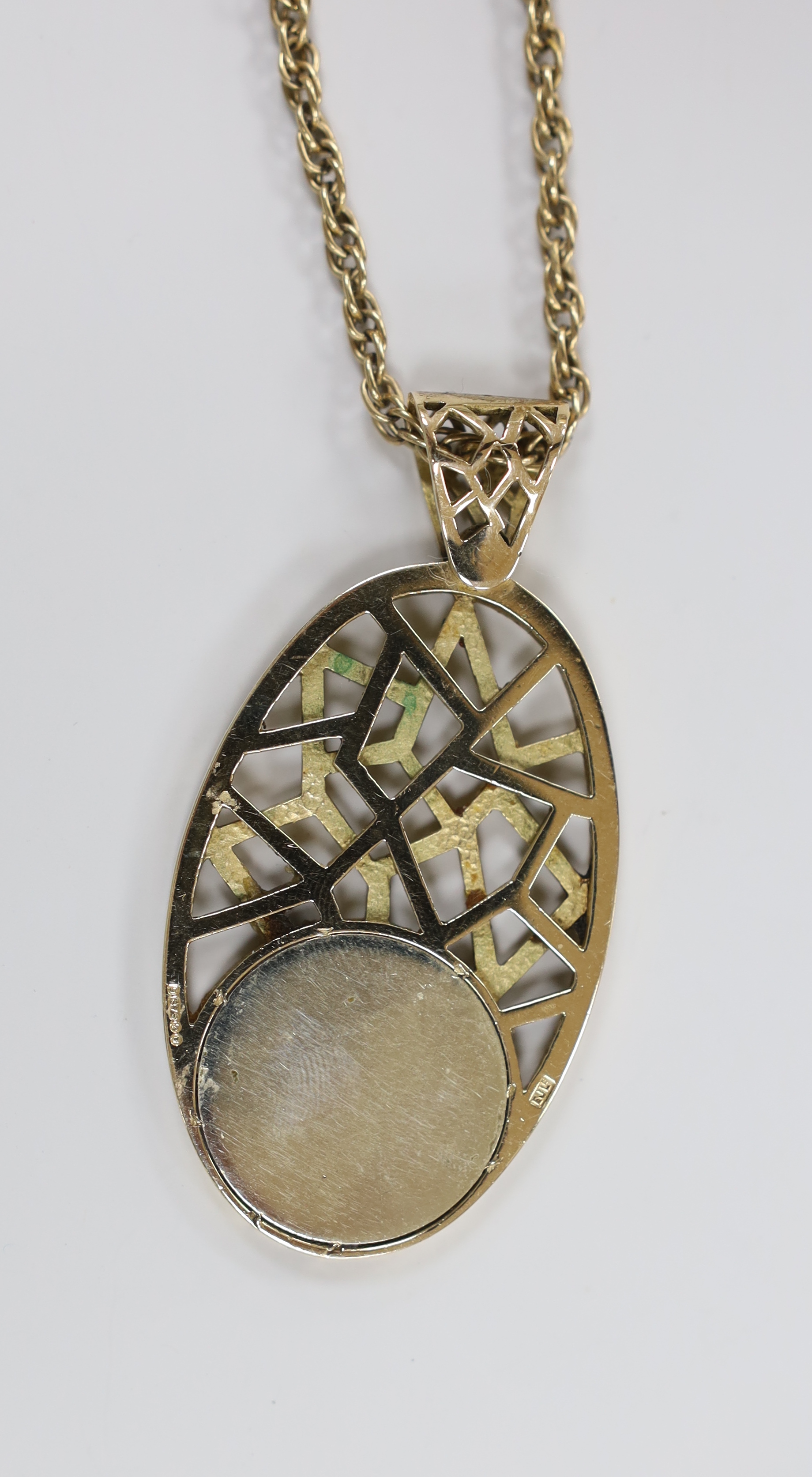 A 1970's pierced 9ct yellow gold and enamel sign of the zodiac oval pendant depicting Cancer, 74mm, gross weight 33.3 grams, on an associated yellow metal chain, 64cm, 18 grams.